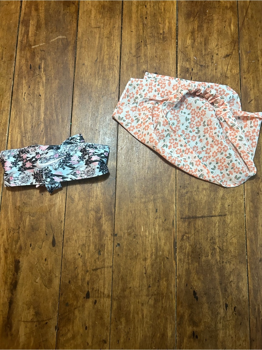 1 Floral blue pink and black Nike headband and 1 orange white and green headband